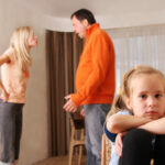 Husband and wife arguing in front of their child 